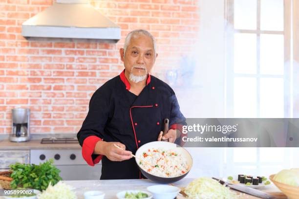 asian chef preparing rice with vegetables - tripod fish stock pictures, royalty-free photos & images