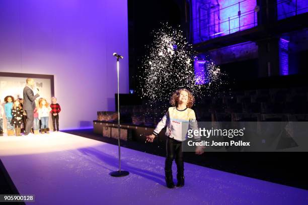 Model throws gold confetti in the air on the runway ahead of the Sportalm show during the MBFW January 2018 at ewerk on January 17, 2018 in Berlin,...