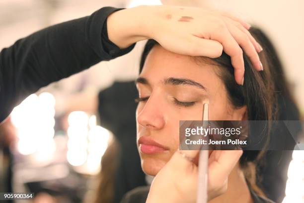 Makeup artists working backstage ahead of the Sportalm show during the MBFW January 2018 at ewerk on January 17, 2018 in Berlin, Germany.