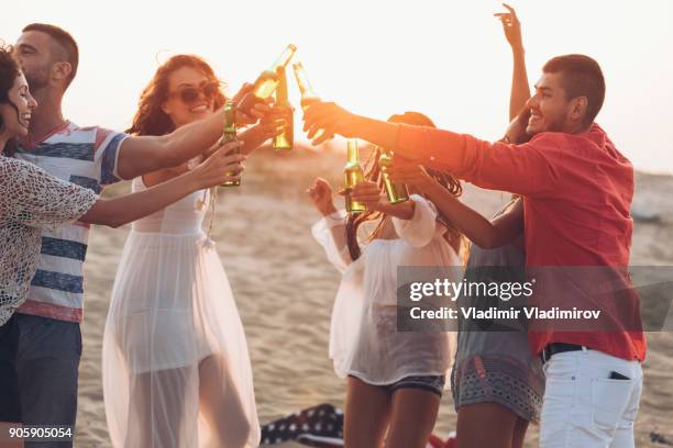 hipster friends at beach on sunset - sunset beach party stock pictures, royalty-free photos & images