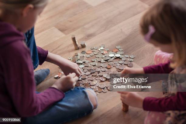 two children counting out pocket money - pocket money stock pictures, royalty-free photos & images
