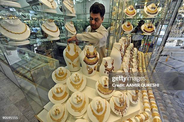 Pakistani worker adjusts jewellery on display at his gold workshop in Rawalpindi on September 9, 2009. Gold prices in Pakistan on September 9 touched...