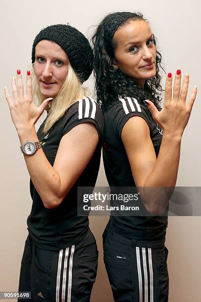 Anja Mittag and Fatmire Bajramaj pose with their black-red-gold coloured fingernails at the Holiday Inn hotel on September 9, 2009 in Helsinki,...