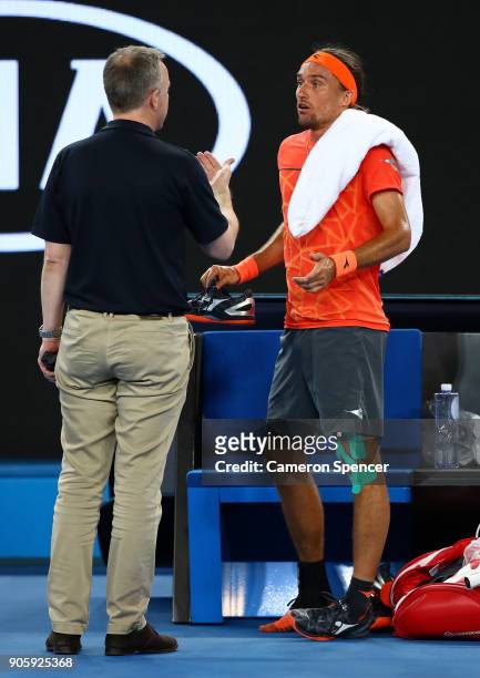 Alexandr Dolgopolov of the UkraineÊtalks to a Grand Slam Supervisor after losing his shoe in his second round match against Matthew Ebden of...