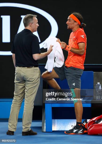 Alexandr Dolgopolov of the UkraineÊtalks to a Grand Slam Supervisor after losing his shoe in his second round match against Matthew Ebden of...