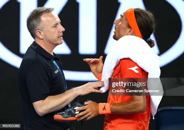 Alexandr Dolgopolov of the UkraineÊtalks to a Grand Slam Supervisor after losing his shoe in his second round match against Matthew Ebden of...