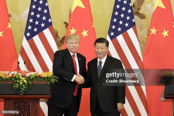 President Donald Trump, left, and Xi Jinping, China's president, shake hands during a news conference at the Great Hall of the People in Beijing,...