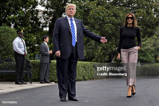 President Donald Trump, center, gestures toward U.S. First Lady Melania Trump before boarding Marine One on the South Lawn of the White House in...