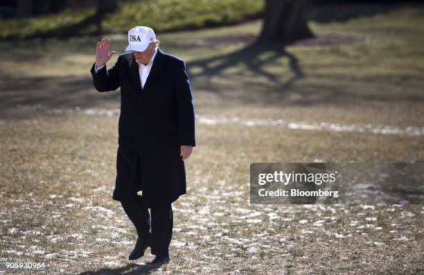 President Donald Trump waves, while returning from a weekend trip with Republican leadership to Camp David, on the South Lawn of the White House in...
