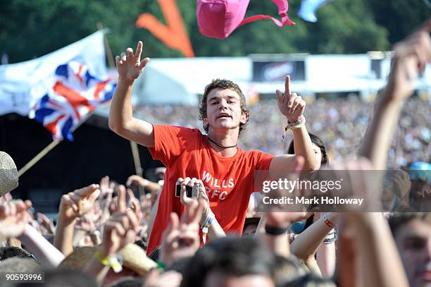 Man sits on shoulders above the crowd on the first day of V Festival at Hylands Park on August 22, 2009 in Chelmsford, England.