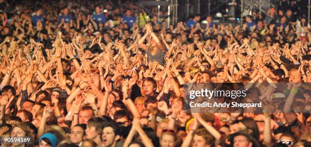 General view of fans in the crowd raising their arms in unison and clapping and viewed from the front on Day 2 of Reading Festival 2009 on August 29,...