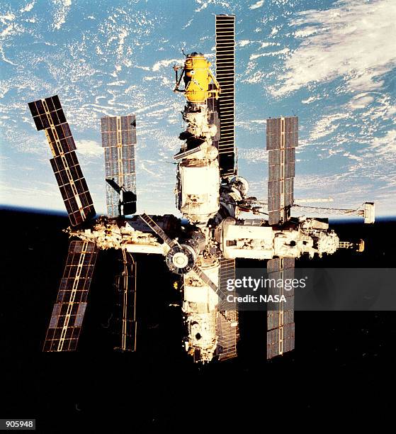 Russia's Mir Space Station backdropped against a cloud-covered Earth was photographed during a fly-around by the Space Shuttle Endeavour. On August...