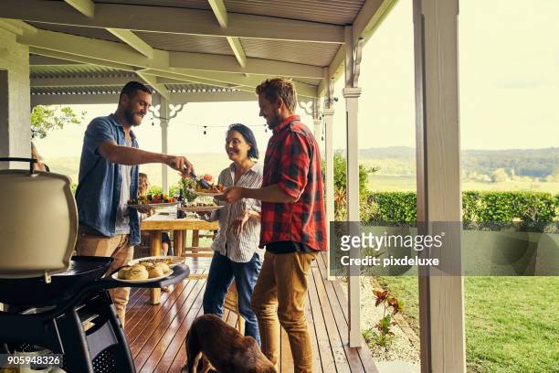 he sure knows how to host a lunch - barbecue social gathering stock pictures, royalty-free photos & images