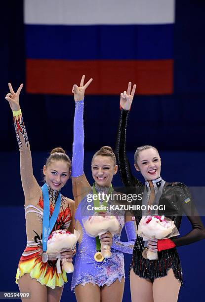 Individual all-around world champion Evgenia Kanaeva of Russia shares the podium with second place Daria Kondakova of Russia and third place Anna...