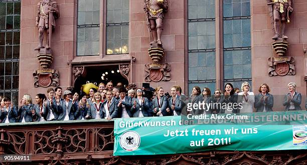 Players celebrate during a reception for the German women's national team on the balcony of the city hall 'Roemer' on September 11, 2009 in Frankfurt...