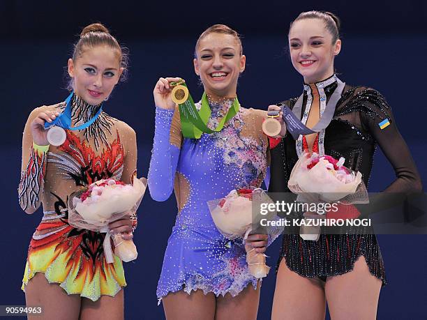 Individual all-around world champion Evgenia Kanaeva of Russia shares the podium with second place Daria Kondakova of Russia and third place Anna...