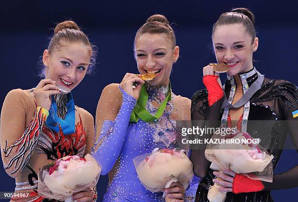 Individual all-around world champion Evgenia Kanaeva of Russia shares the podium with second place Daria Kondakova of Russia and third place Anna...