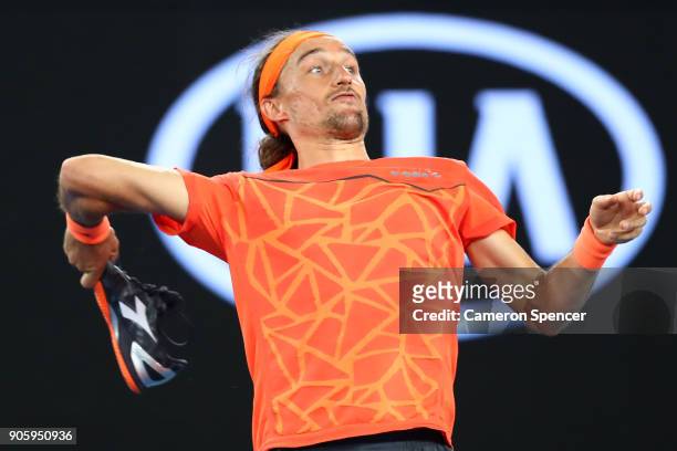 Alexandr Dolgopolov of the Ukraine throws his shoes into the crowd after winning his second round match against Matthew Ebden of Australia on day...