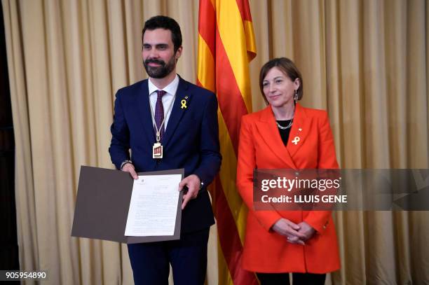 Newly elected parliament speaker Roger Torrent receives his briefcase from outgoing speaker Carme Forcadell after Catalan's parliament inaugural...