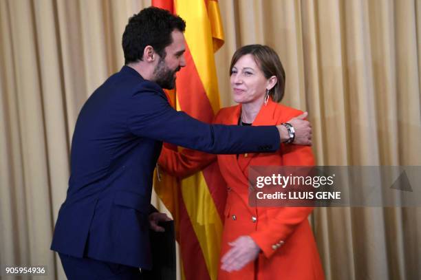 Newly elected parliament speaker Roger Torrent is congratulated by former speaker Carme Forcadell after Catalan's parliament inaugural session on...