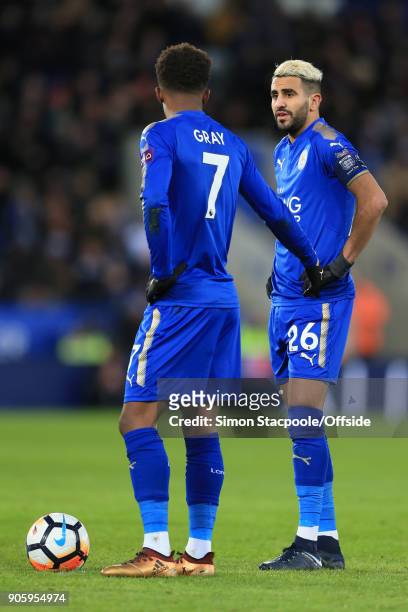 Riyad Mahrez of Leicester speaks to teammate Demarai Gray during The Emirates FA Cup Third Round Replay match between Leicester City and Fleetwood...