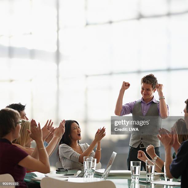 man celebrating during business meeting - applauding leader stock pictures, royalty-free photos & images