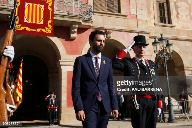 Newly elected parliament speaker Roger Torrent reviews members of the Catalan regional police force Mossos d'Esquadra after Catalan's parliament...