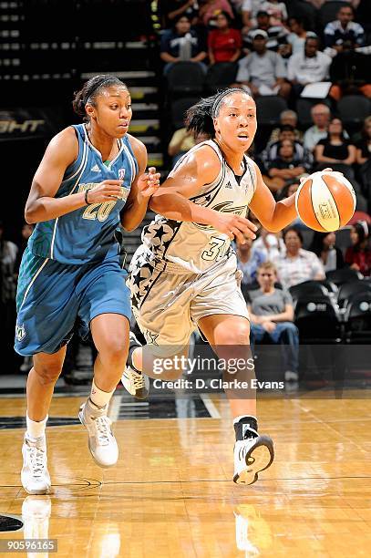 Helen Darling of the San Antonio Silver Stars drives up court against Renne Montgomery of the Minnesota Lynx during the WNBA game on September 1,...