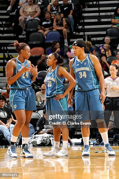 Charde Houston, Renee Montgomery and Tasha Humphrey of the Minnesota Lynx talk together during the WNBA game against the San Antonio Silver Stars on...