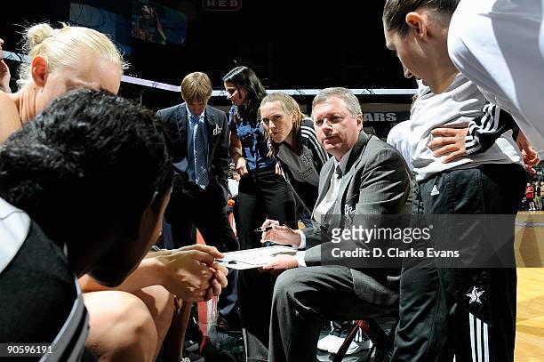 Head coach Dan Hughes of the San Antonio Silver Stars huddles with his players during the WNBA game against the Minnesota Lynx on September 1, 2009...