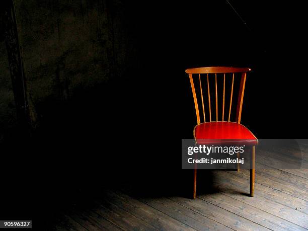 wood chair with red seat in dark room with wood floor - red chair stock pictures, royalty-free photos & images