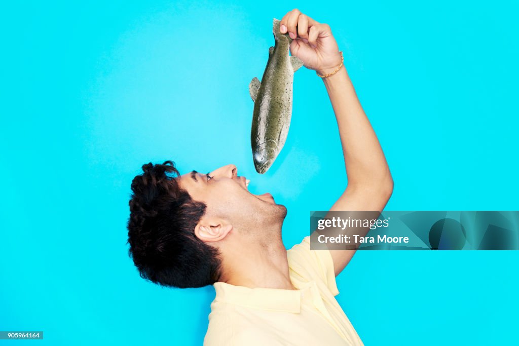Man eating whole fish