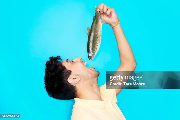man eating whole fish - mouth open eating stock pictures, royalty-free photos & images