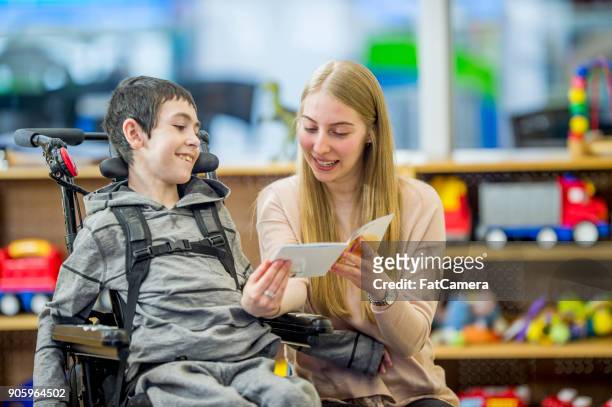 reading a story - physical disability stock pictures, royalty-free photos & images