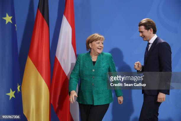 German Chancellor Angela Merkel and new Austrian Chancellor Sebastian Kurz depart after speaking to the media following talks at the Chancellery on...