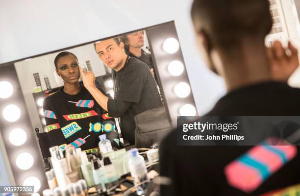 Models gets prepared backstage ahead of the Irene Luft show during the MBFW January 2018 at ewerk on January 17, 2018 in Berlin, Germany.