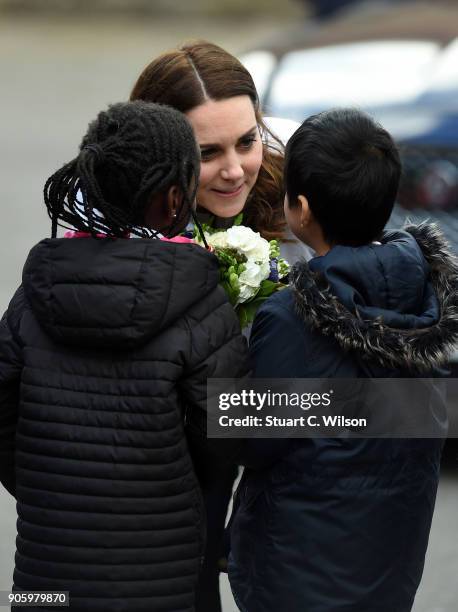 Catherine, Duchess of Cambridge is greeted by children as she visits The Wimbledon Junior Tennis Initiative at Bond Primary School on January 17,...