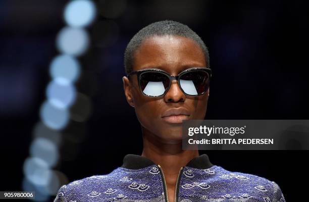 Model presents a creation by the label "Irene Luft" during the Fashion Week in Berlin on January 17, 2018. / AFP PHOTO / dpa / Britta Pedersen /...