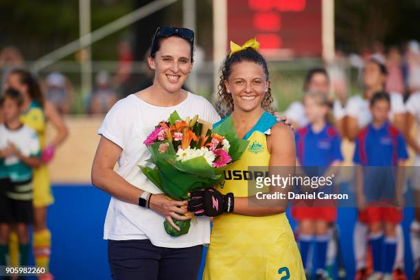 Ambrosia Malone of the Hockeyroos is presented flowers on debut by Madonna Blyth during game two of the International Test Series between the...