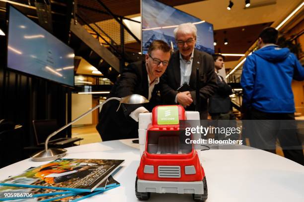 Fedor Maas, solution architect at Ericsson AB, left, stands by a model truck while demonstrating 5G fleet and logistic remote management on an...