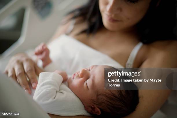 close up of newborn girl with mom at bed in hospital - newborn hospital stock pictures, royalty-free photos & images