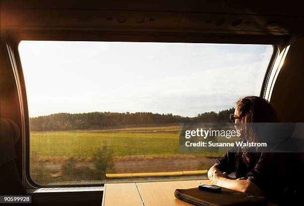 a woman on a train sweden. - scheibe stock-fotos und bilder