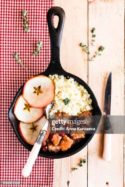 pork stew with dried cranberry served with couscous in a pan, selective focus - homemade apple sauce stock pictures, royalty-free photos & images