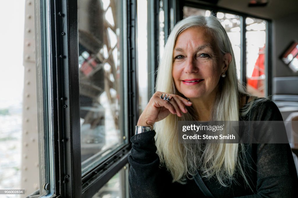 Portrait of smiling Caucasian woman near window