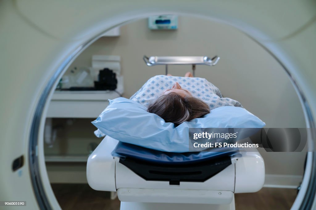 Caucasian patient laying on scanner table
