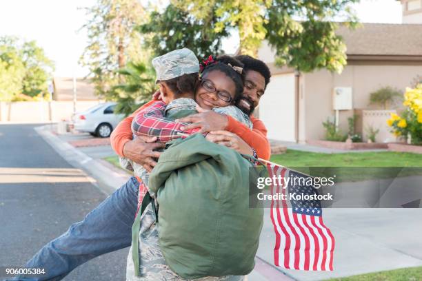 black woman soldier hugging man and daughter - african american soldier bildbanksfoton och bilder