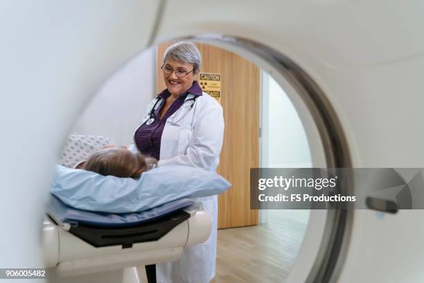 doctor talking to patient at scanner - medical scanning equipment stock pictures, royalty-free photos & images