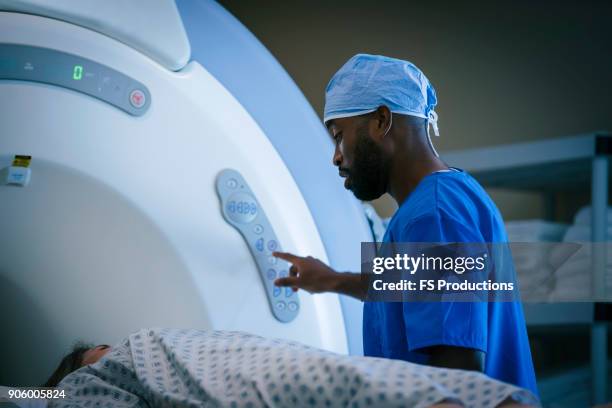 technician talking to patient at scanner - examination closeup stock pictures, royalty-free photos & images