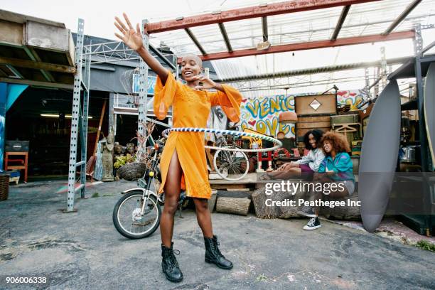 Friends watching woman spinning hoop around waist