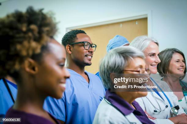 portrait of smiling medical team - surgical cap stock pictures, royalty-free photos & images